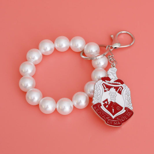 White Red Shield Pearl Keychain|7.75 x 1.65 inches - Premium Wholesale Fashion Accessories from Pinktown - Just $18! Shop now at chiquestyles
